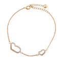 Gold-plated bracelet with double open pavé heart design on a white background