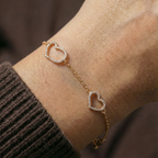 Double heart charm bracelet worn on wrist