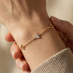 Delicate triangle charm bracelet worn on wrist