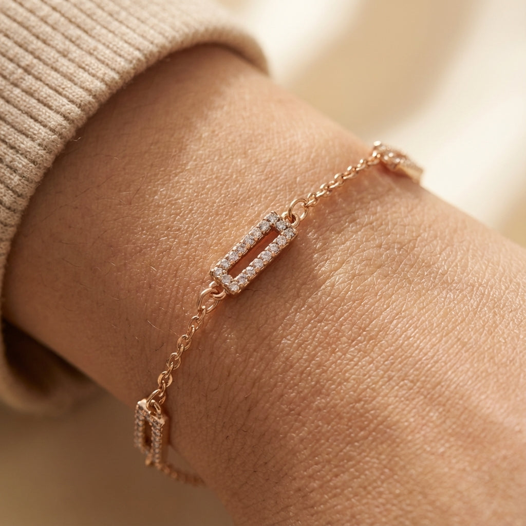 Gold-plated bar link bracelet worn on wrist