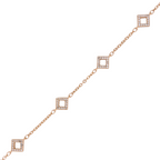 Close-up of diamond-tilt square pavé charms on gold chain bracelet