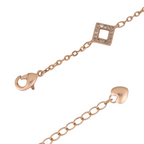 Lobster clasp and square link detail on gold-plated bracelet on a white background