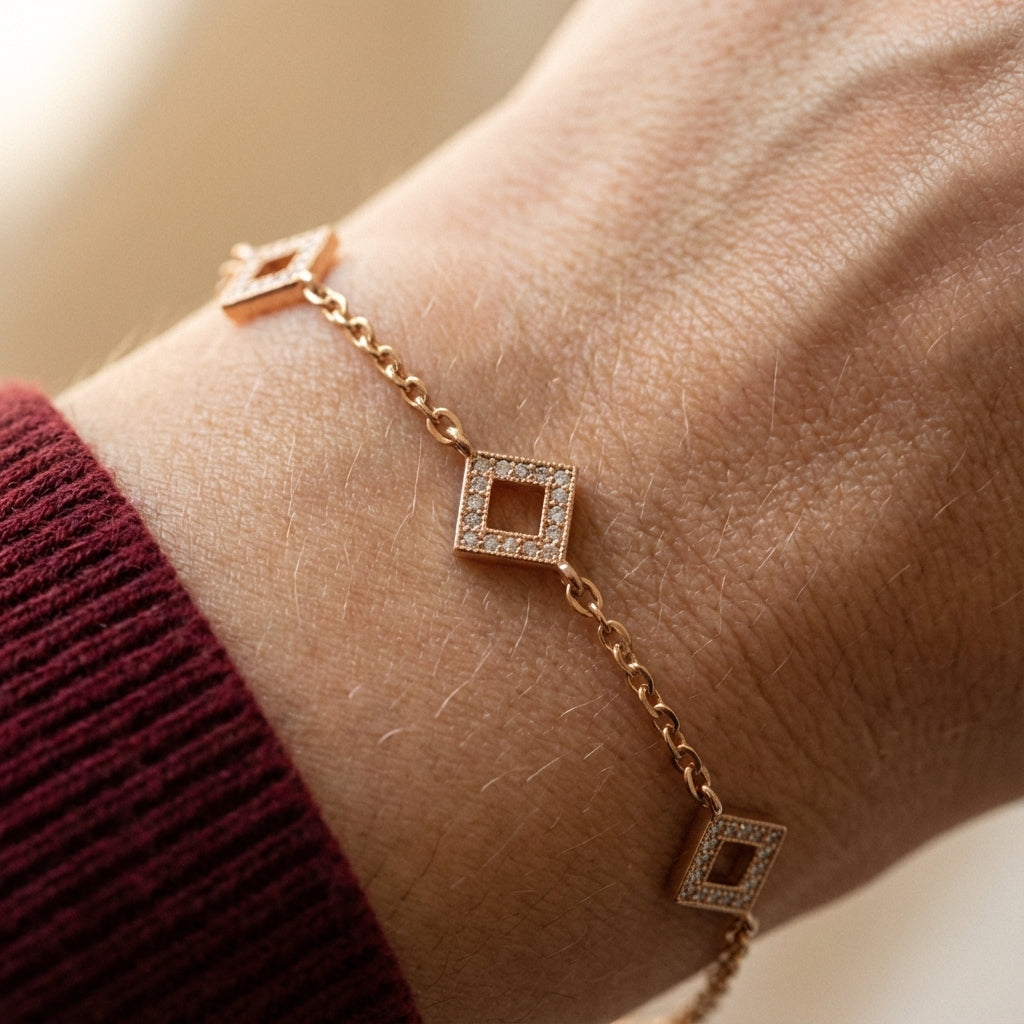 Gold-plated square charm bracelet worn on wrist