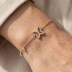 Gold-plated butterfly bracelet worn on wrist