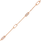Close-up of rectangular link and pavé bar detailing on gold bracelet on a white background