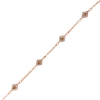 Close-up of diamond-shaped micro-pavé charms on gold chain bracelet on a white background