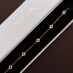 Gold-plated diamond charm bracelet displayed in Zircon Jewels gift box