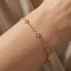 Gold-plated geometric charm bracelet worn on wrist