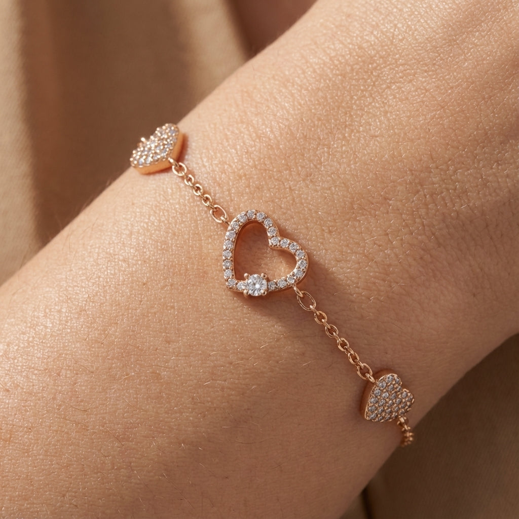 Gold-plated heart charm bracelet worn on wrist