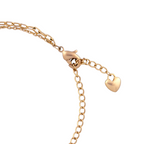 Gold bracelet lobster clasp with adjustable extender chain and small heart charm. on a white background