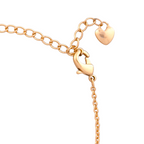 Gold bracelet with heart-shaped charm on a white background