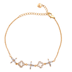 Gold bracelet with decorative links on a white background