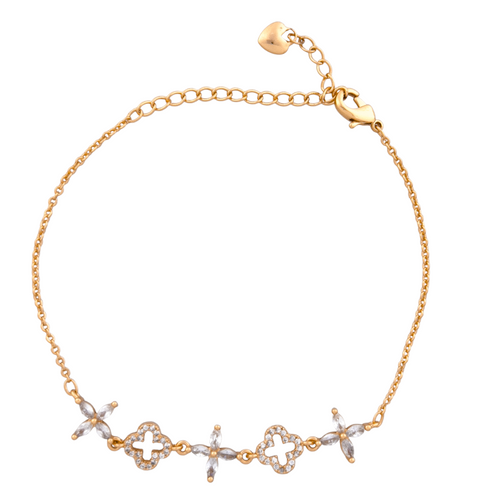Gold bracelet with decorative links on a white background