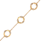 Gold bracelet with interlocking circular links on a white background