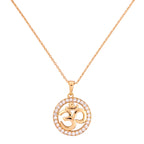 Gold-plated necklace with a round pendant featuring an Om symbol inside a clear stone halo on a white background