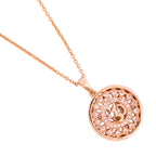 Close-up of the round Om pendant detail with clear stones