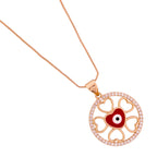 Close-up of the circular pendant: heart cut-out details + red enamel evil eye