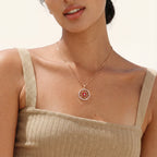 Red evil-eye medallion necklace worn on the neck
