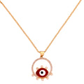 Gold-plated evil eye pendant necklace with red enamel and pavé halo on a white background