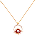 Gold-plated evil eye pendant necklace with red enamel and pavé halo on a white background