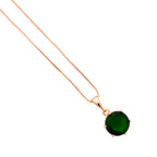 Close-up of the round emerald green stone pendant detail
