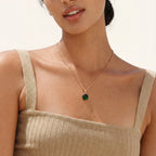 Emerald green stone pendant necklace worn on the neck