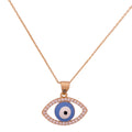 Gold-plated evil eye pendant necklace with a pavé border on a white background