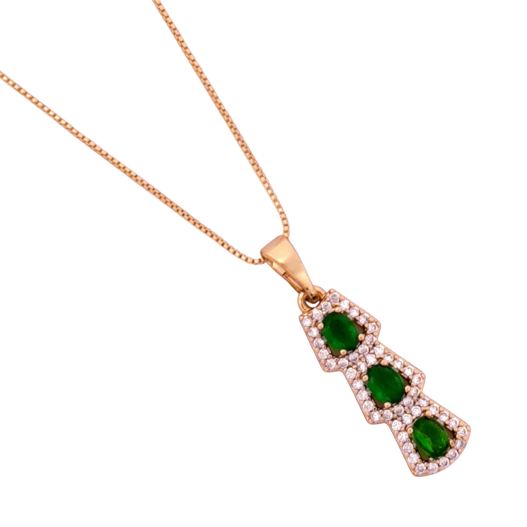 Gold necklace with a pendant featuring green gemstones on a white background